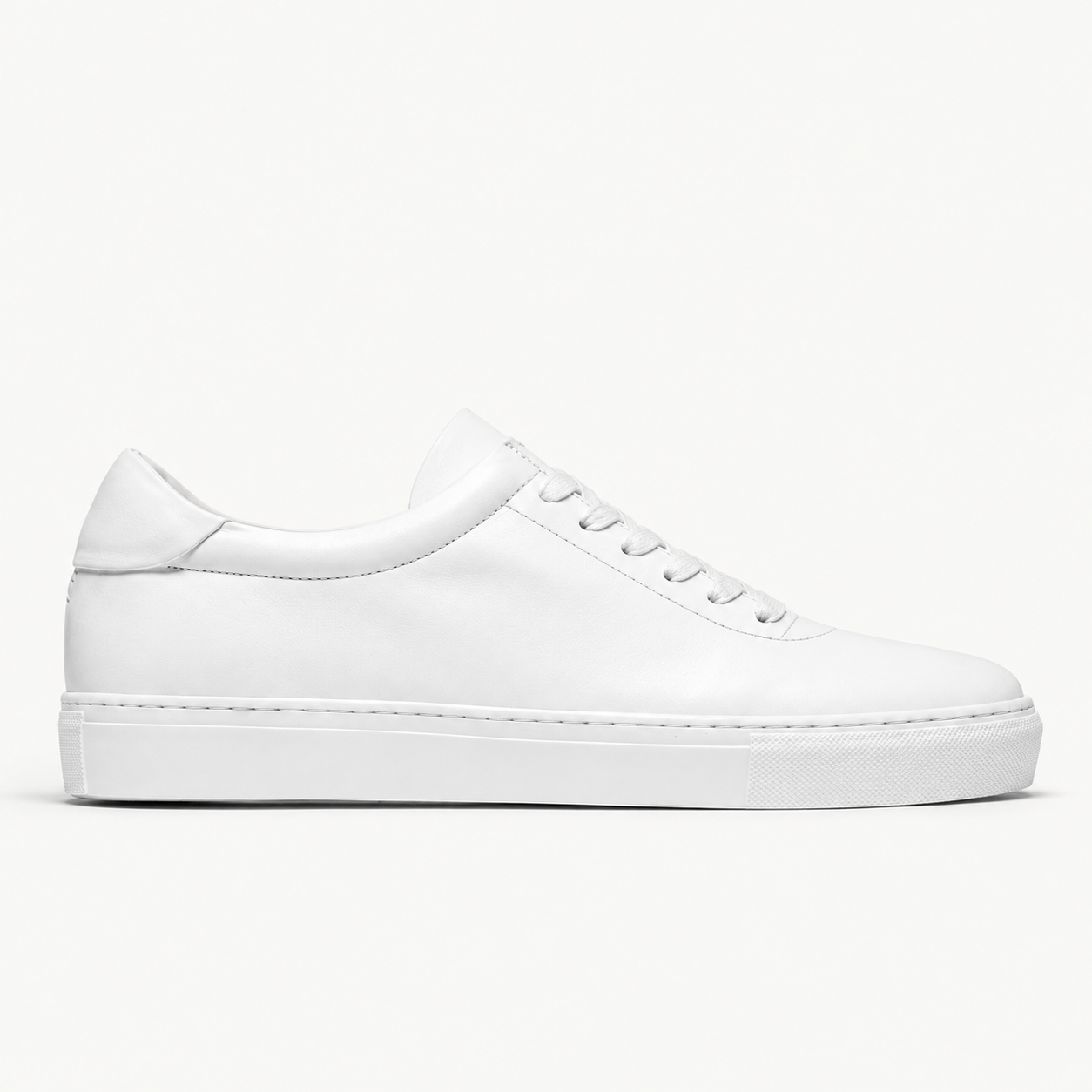 The Proper Sneaker® — white leather, side profile on the Maison studio background.