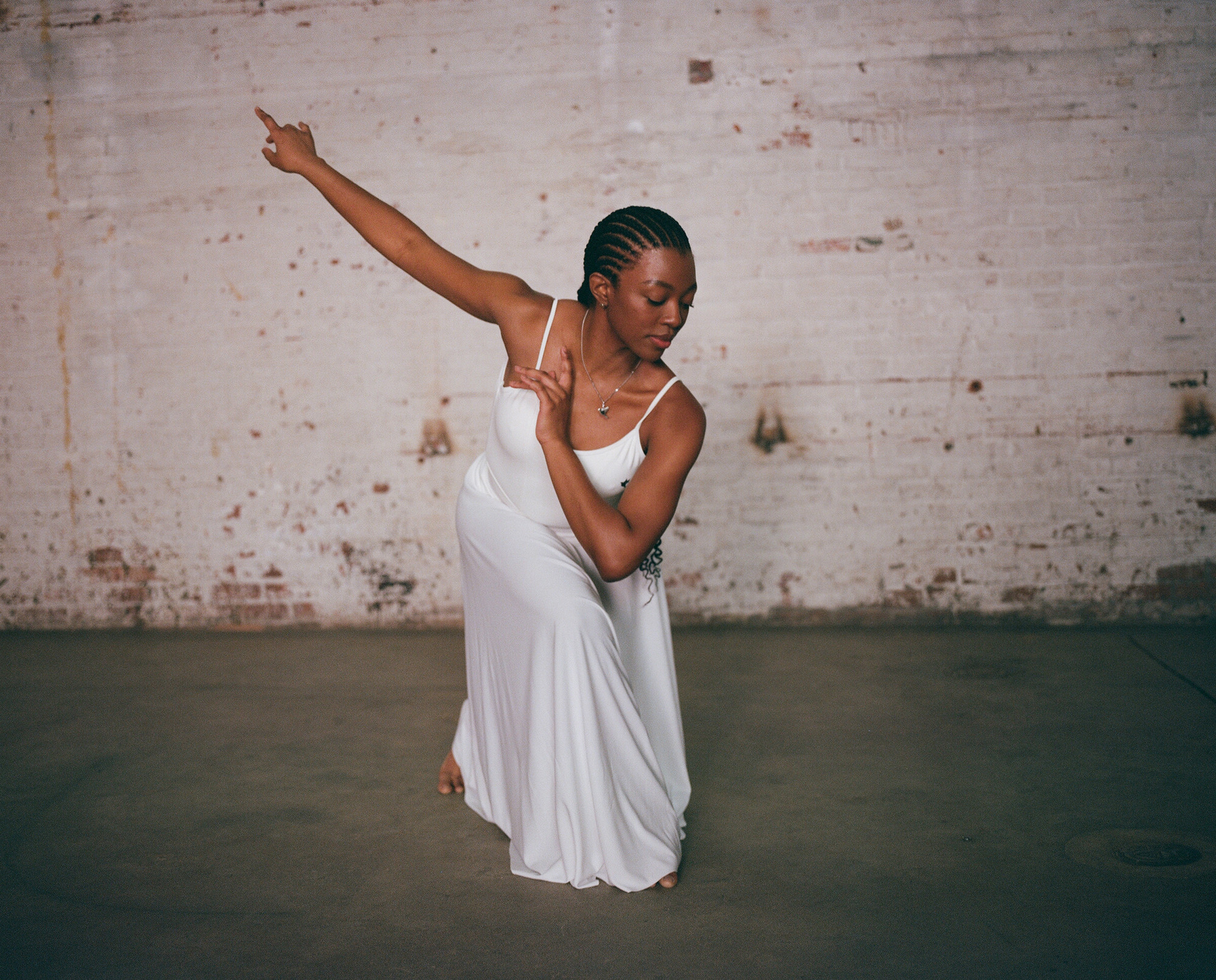 Ballet dancer Deja Robinson performs in a white dress on the New York film set.
