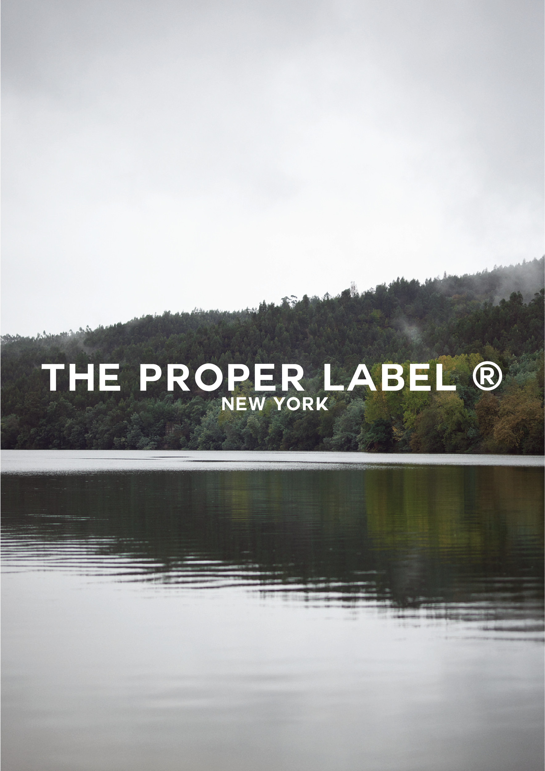 A quiet lake and wooded hillside beneath The Proper Label wordmark.